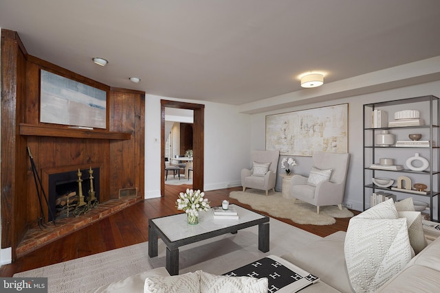 living room featuring a brick fireplace and hardwood / wood-style floors