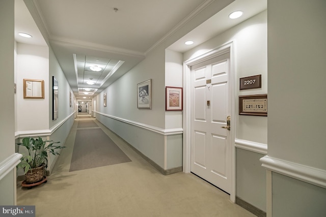 hallway featuring light carpet and ornamental molding