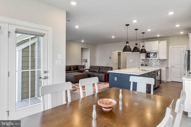 dining room with hardwood / wood-style flooring and sink