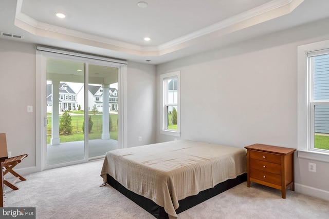 bedroom featuring a raised ceiling, ornamental molding, light carpet, and access to exterior