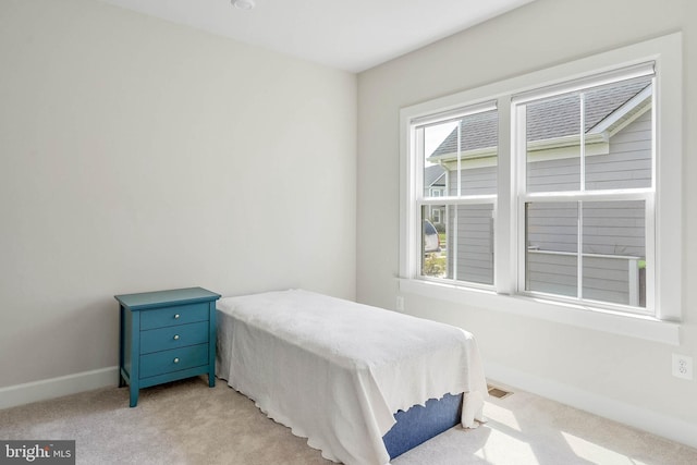 bedroom featuring light colored carpet