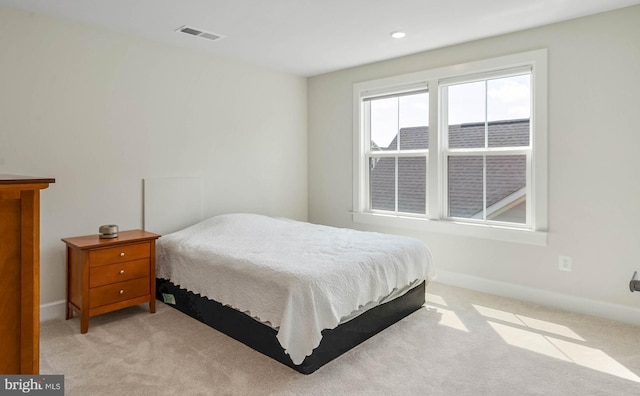 bedroom featuring light carpet