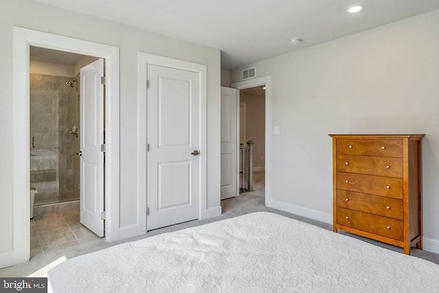 unfurnished bedroom with light colored carpet and ensuite bathroom