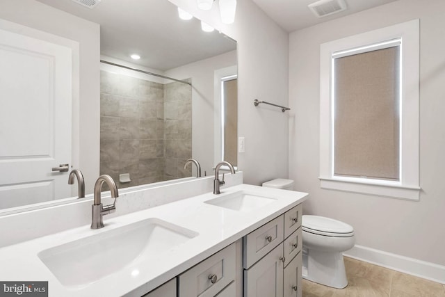 bathroom with tile patterned flooring, vanity, and toilet