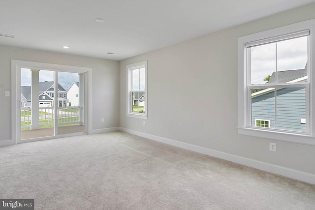 unfurnished room featuring light carpet