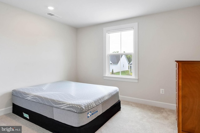 carpeted bedroom featuring multiple windows