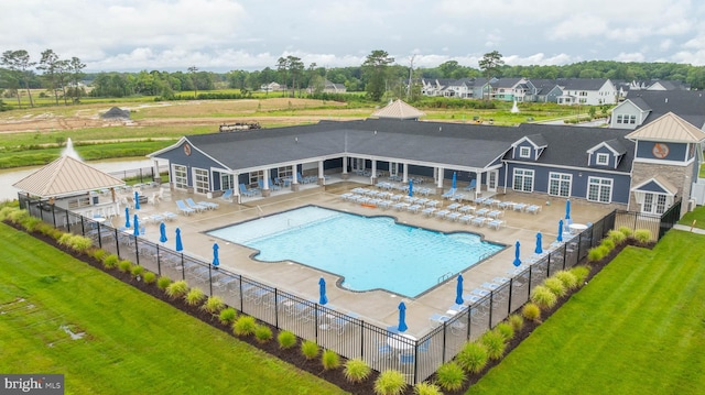 view of swimming pool featuring a patio and a yard