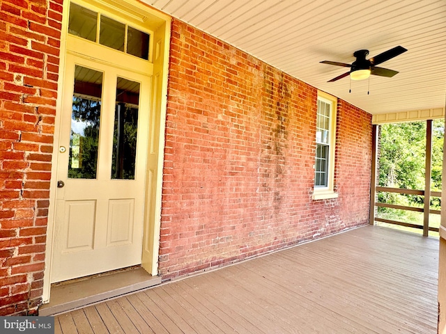 view of exterior entry featuring ceiling fan