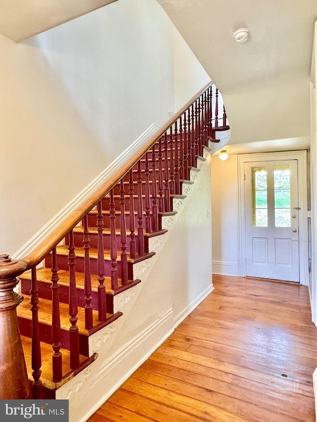 staircase featuring hardwood / wood-style floors