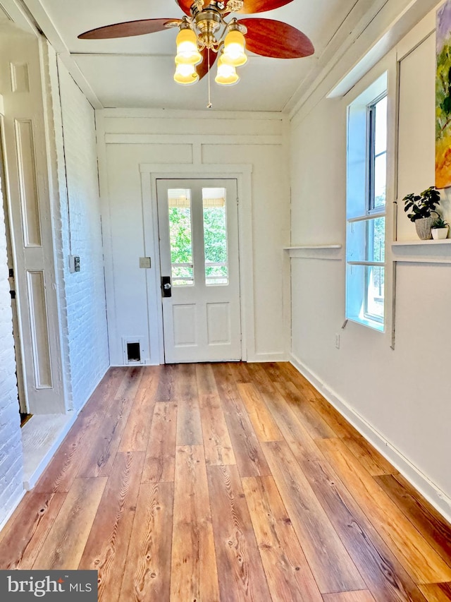 doorway featuring ceiling fan, plenty of natural light, and light hardwood / wood-style floors