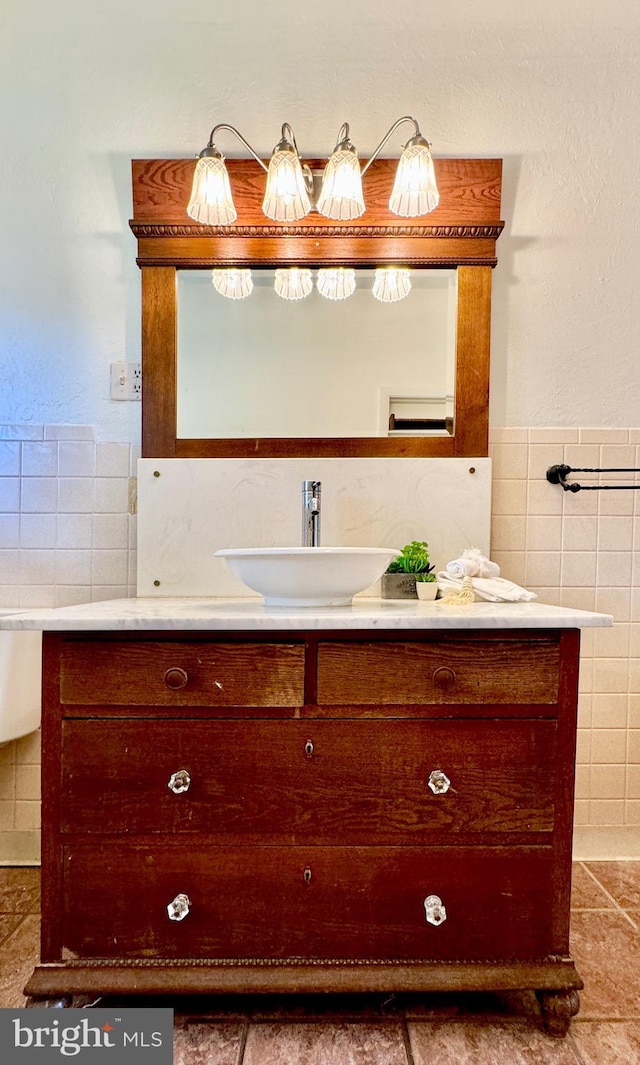 bathroom featuring tile patterned flooring, vanity, and tile walls