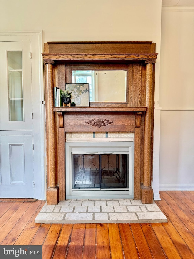 interior details with crown molding and hardwood / wood-style floors