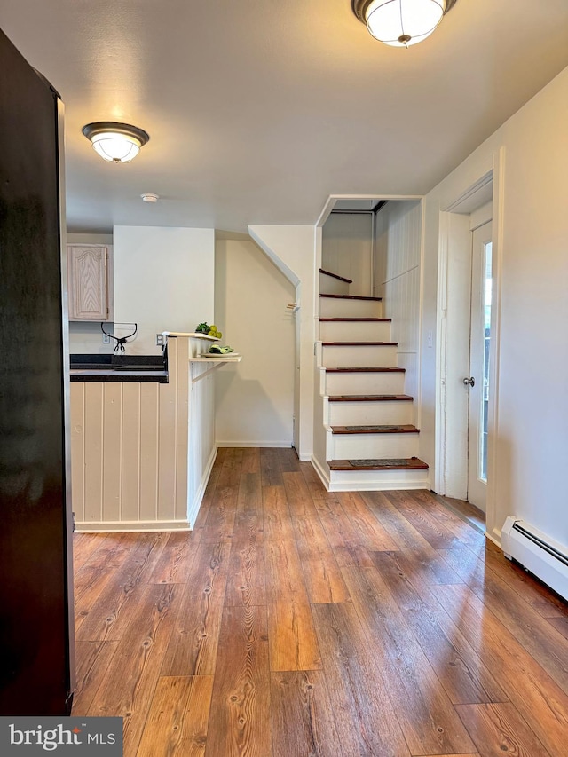 interior space featuring a baseboard radiator and dark hardwood / wood-style flooring