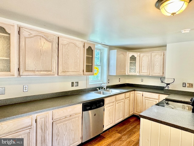 kitchen with stainless steel dishwasher, sink, hardwood / wood-style floors, and light brown cabinets