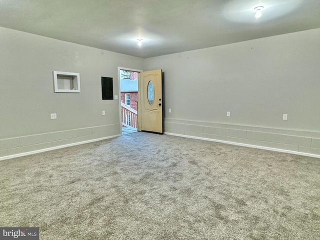 carpeted spare room featuring baseboards