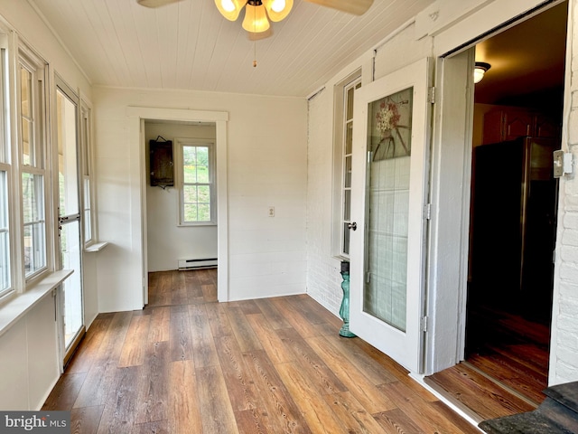 unfurnished sunroom with a baseboard radiator and ceiling fan