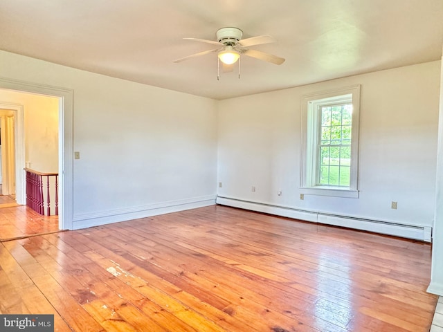 empty room with light wood-type flooring, ceiling fan, and baseboard heating