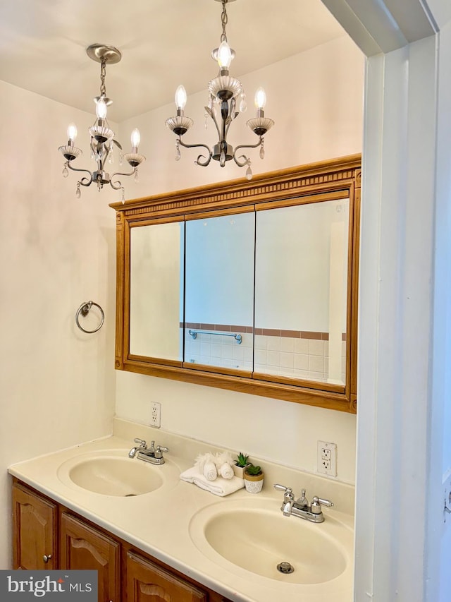 bathroom with vanity and a chandelier