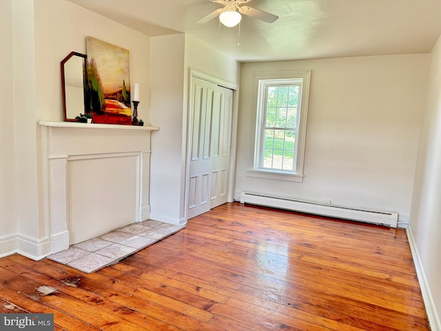 unfurnished living room with baseboard heating, light hardwood / wood-style flooring, and ceiling fan