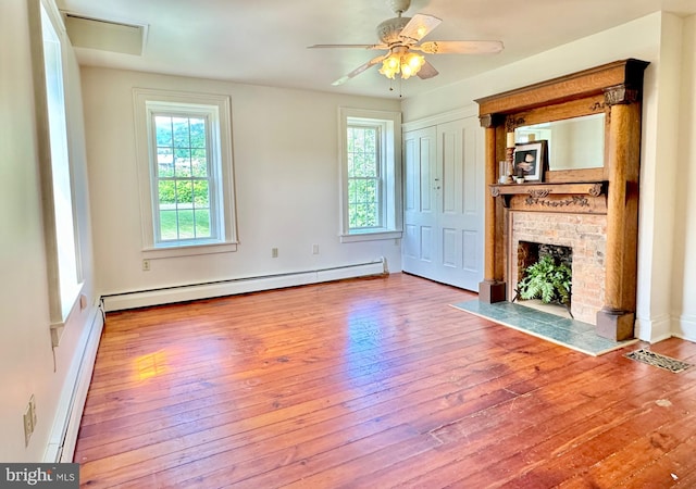 unfurnished living room with a fireplace, wood-type flooring, a baseboard radiator, and ceiling fan