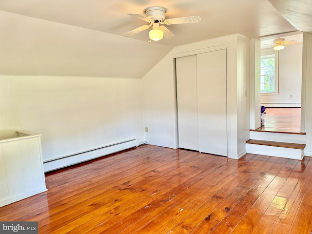 bonus room with baseboard heating, hardwood / wood-style flooring, vaulted ceiling, and ceiling fan