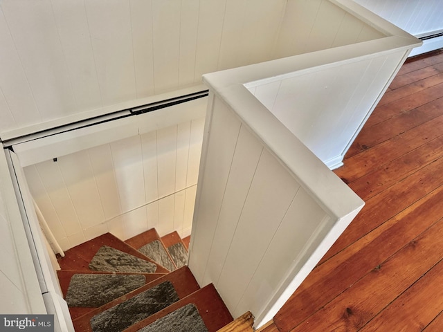 stairs featuring hardwood / wood-style floors