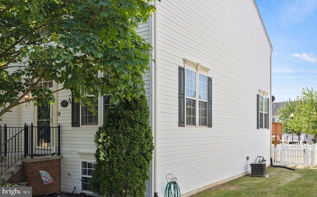 view of side of home with central air condition unit