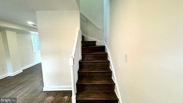 staircase with wood-type flooring