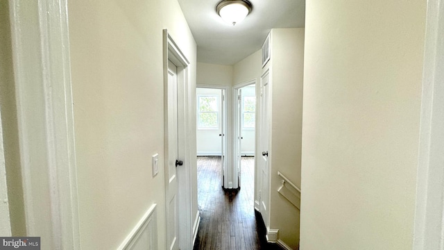 corridor with dark hardwood / wood-style flooring