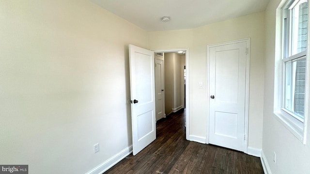 unfurnished bedroom featuring dark hardwood / wood-style flooring