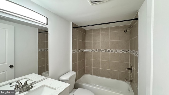 full bathroom featuring toilet, vanity, and tiled shower / bath