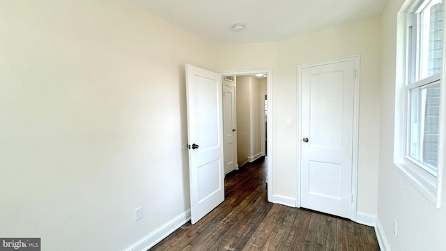 unfurnished bedroom featuring dark hardwood / wood-style floors