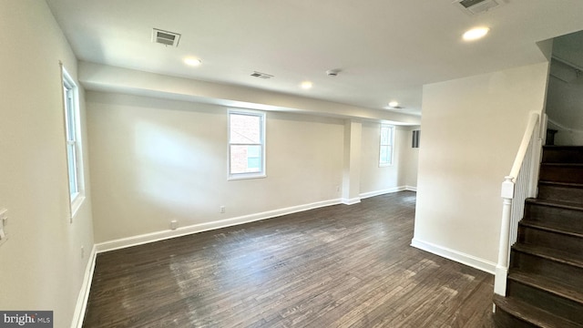 basement with dark hardwood / wood-style floors