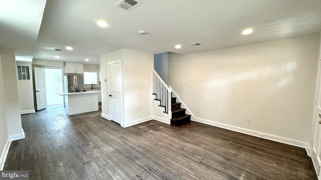 unfurnished living room featuring dark hardwood / wood-style floors