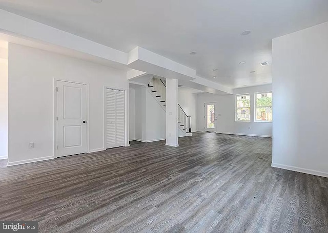 unfurnished living room with dark hardwood / wood-style floors