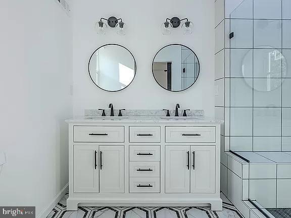 bathroom with a shower and vanity