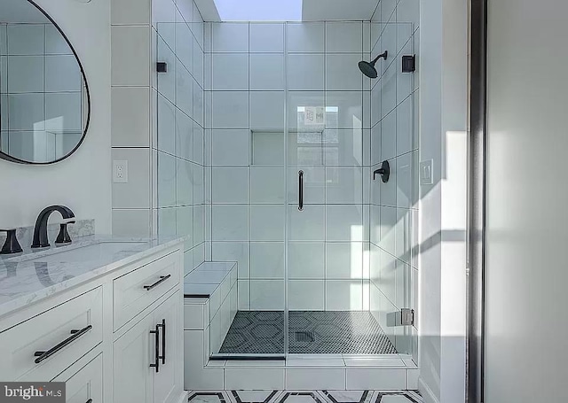 bathroom with an enclosed shower and vanity