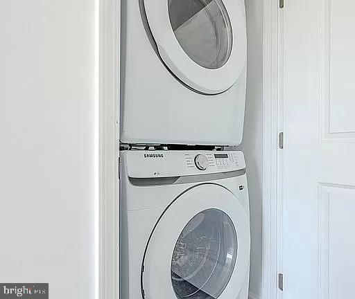 laundry room with stacked washer / dryer