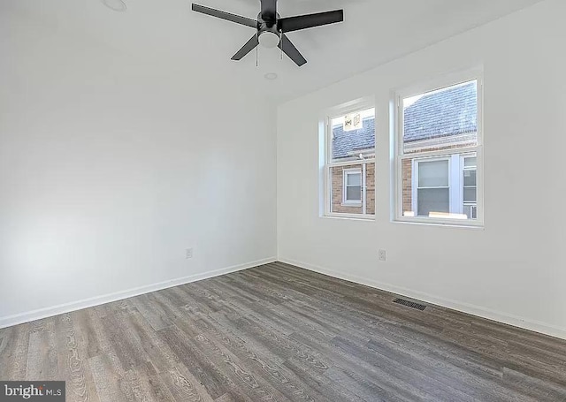 spare room featuring ceiling fan and dark hardwood / wood-style floors