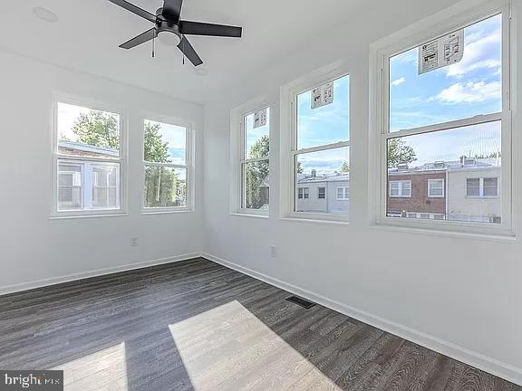 spare room featuring ceiling fan and dark hardwood / wood-style flooring