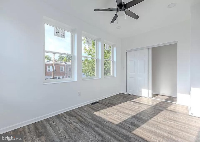 unfurnished bedroom with ceiling fan, hardwood / wood-style flooring, and a closet