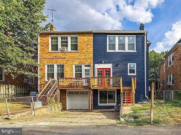 view of front facade with a deck and a garage