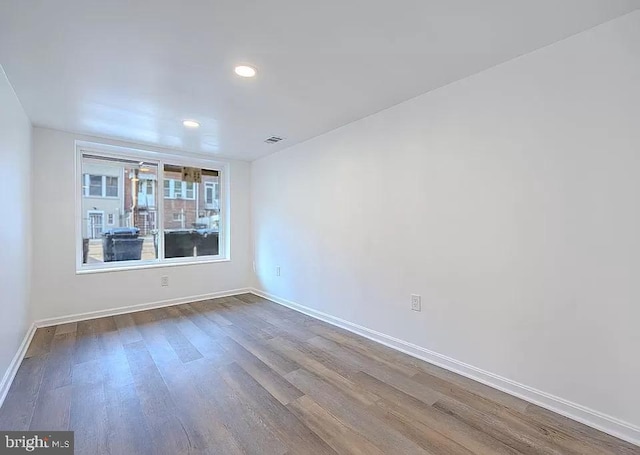 spare room with wood-type flooring