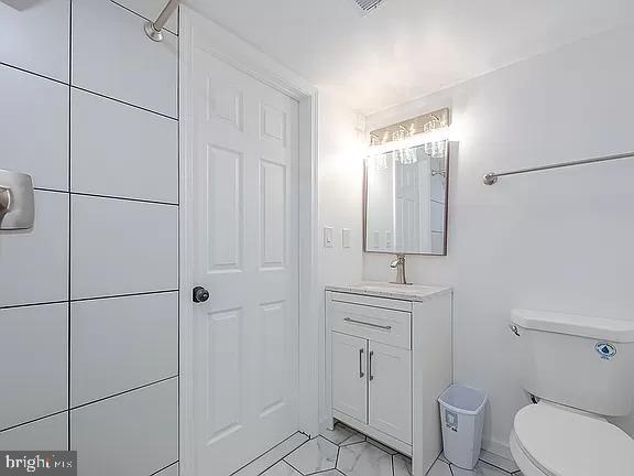 bathroom featuring toilet and vanity