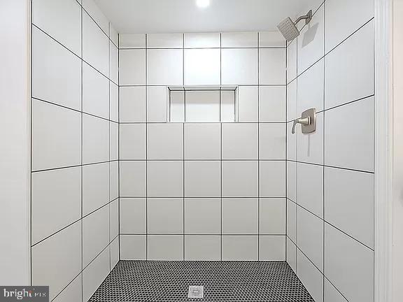 bathroom with tiled shower