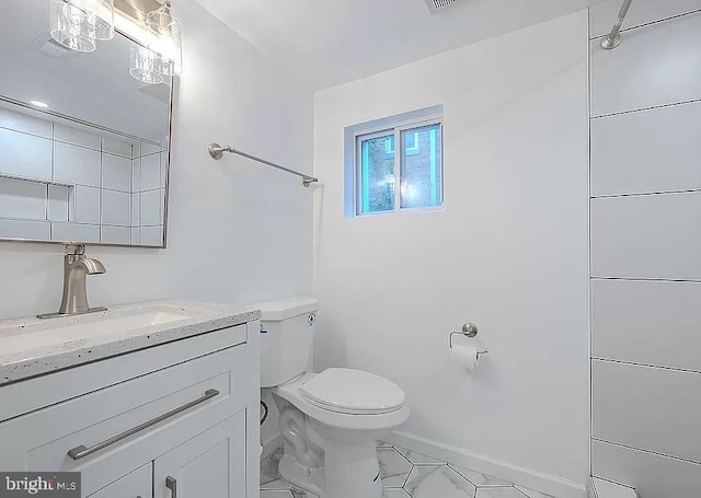 bathroom with toilet and vanity