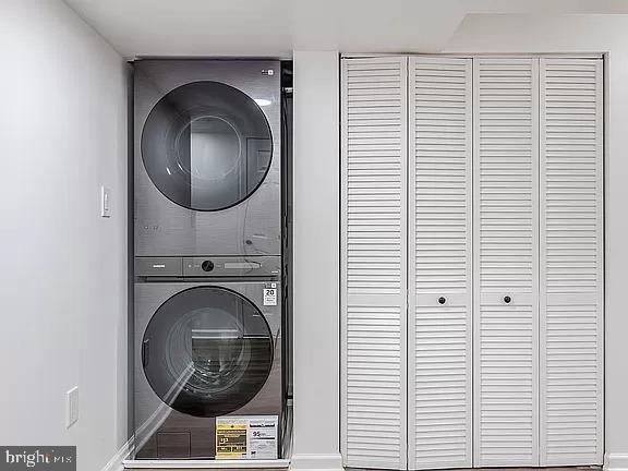 laundry room with stacked washer and clothes dryer