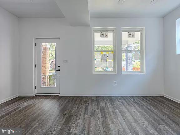 empty room featuring dark hardwood / wood-style flooring