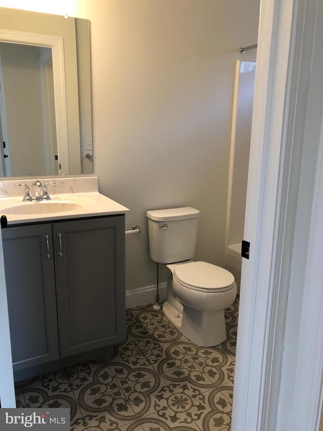 bathroom featuring tile patterned flooring, vanity, and toilet