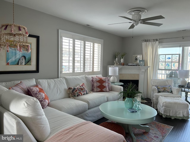 living room with hardwood / wood-style flooring, ceiling fan, and a wealth of natural light